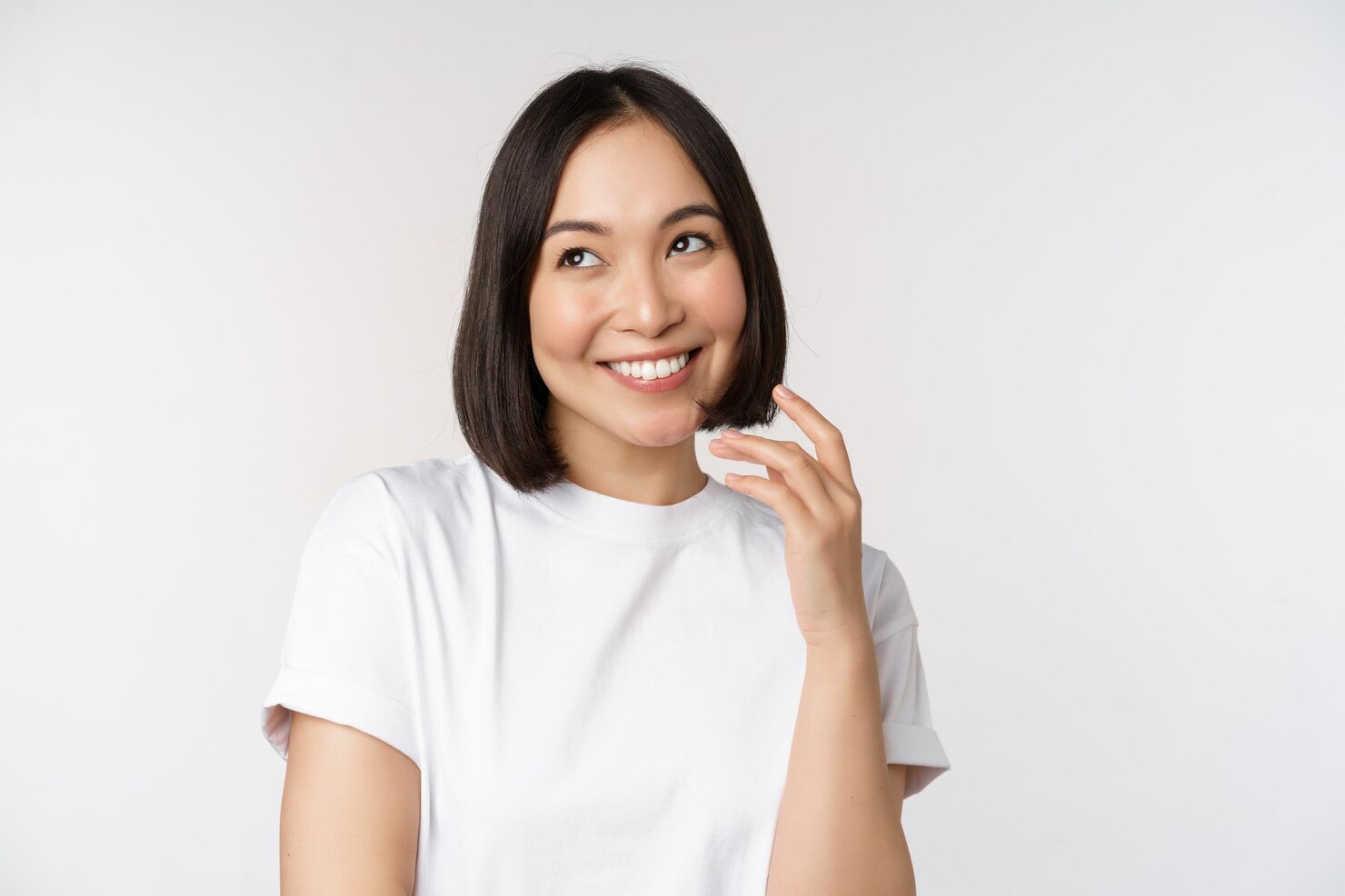 portrait-cute-coquettish-woman-laughing-smiling-looking-aside-thoughtful-thinking-imaging-smth-standing-white-tshirt-studio-background_1258-89211
